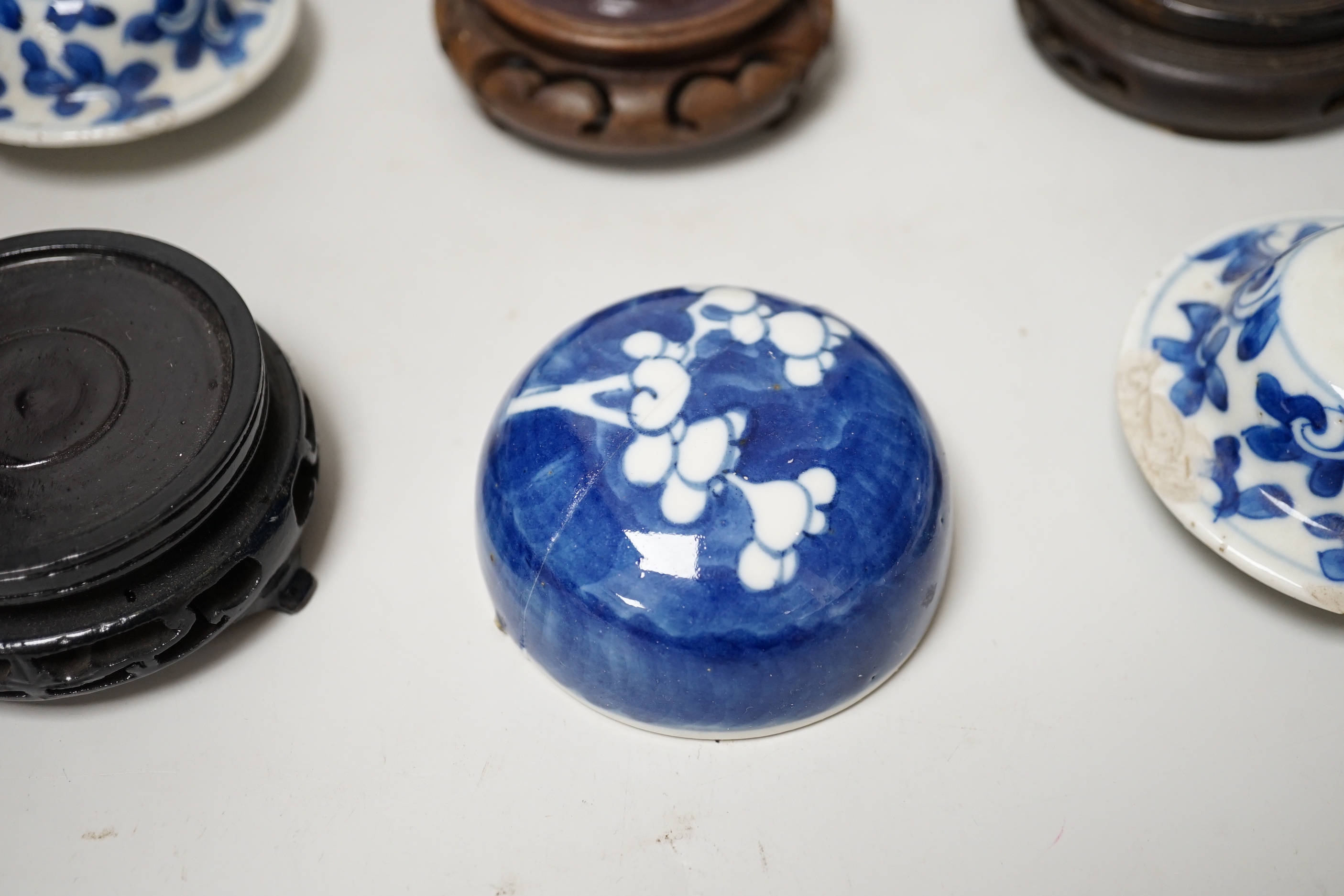 A group of Chinese wooden stands and ceramic lids